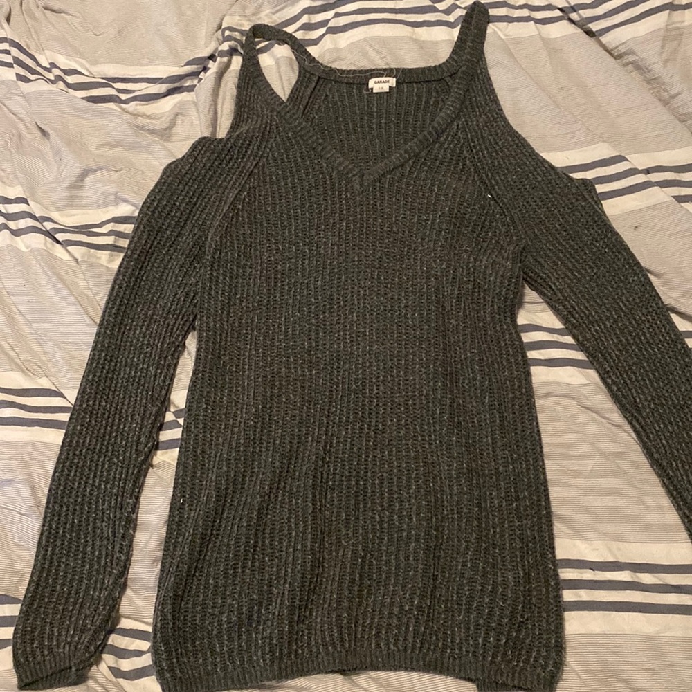 Small gray shoulder showing sweater